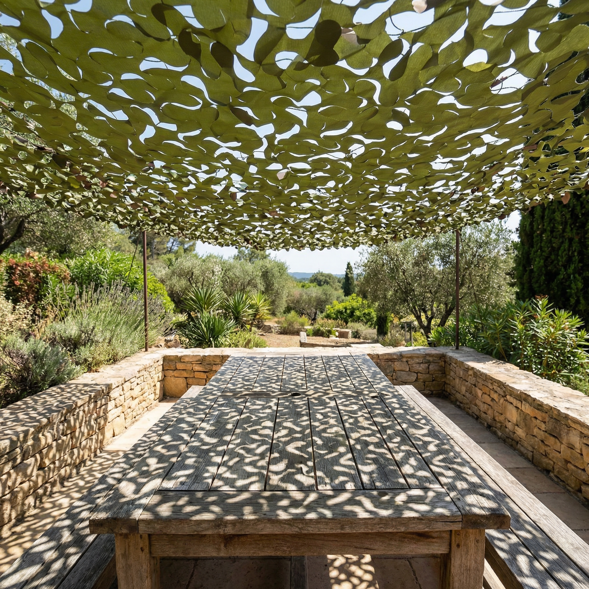 TheFrenchNets woodland print shade net spread over a wooded cabin patio.