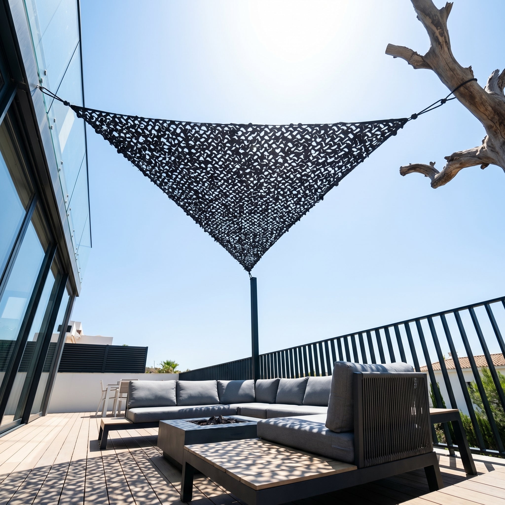 TheFrenchNets graphite triangle shade net anchored above an urban rooftop nook.