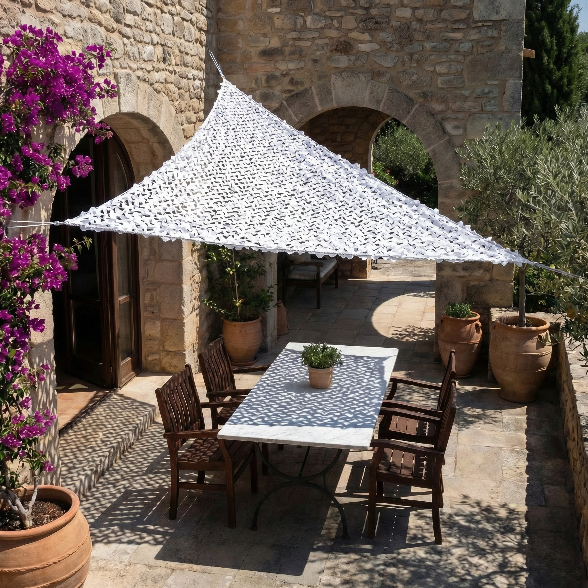 TheFrenchNets white triangle shade net installed at an angled balcony corner.
