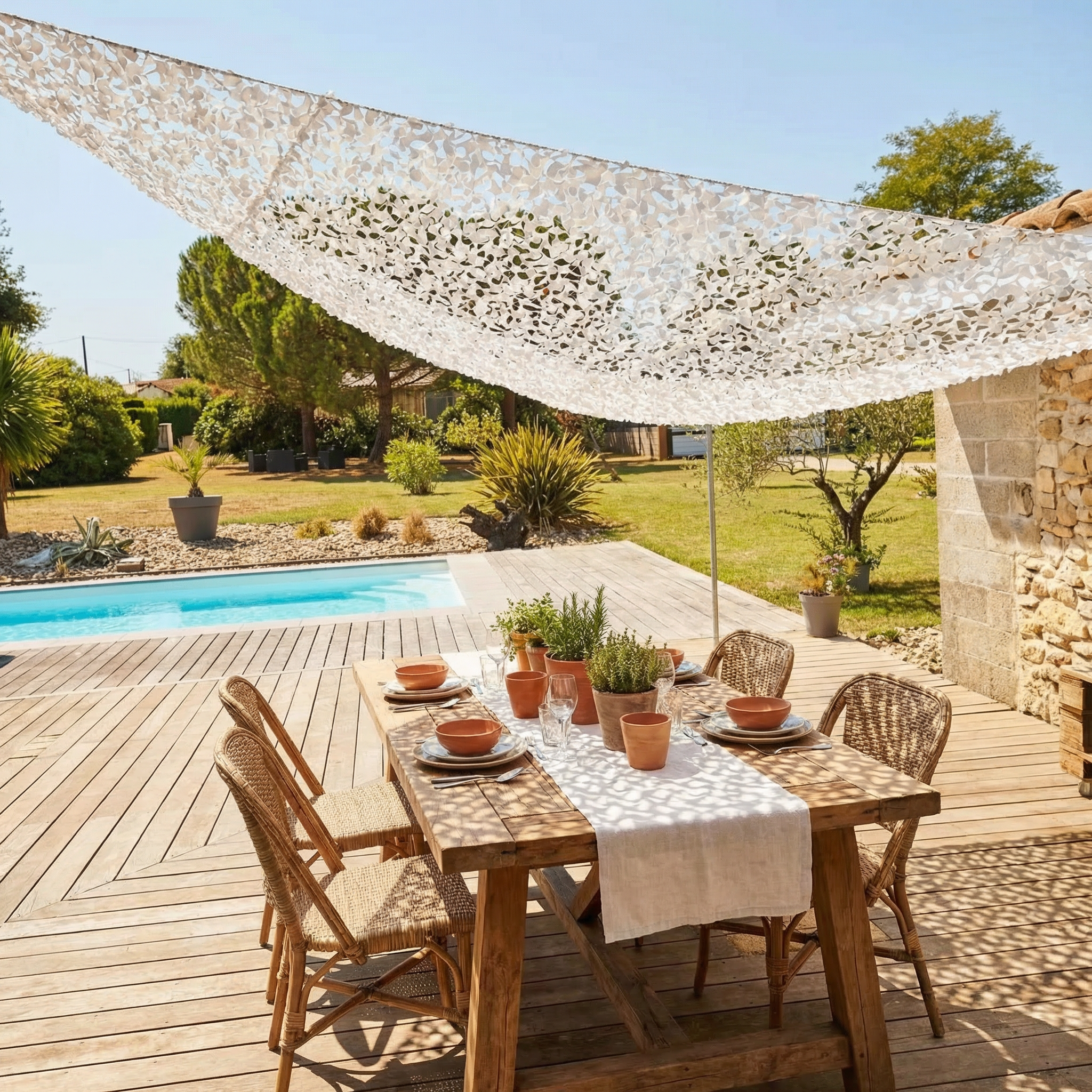 TheFrenchNets white triangle shade net tied to three patio anchor points.