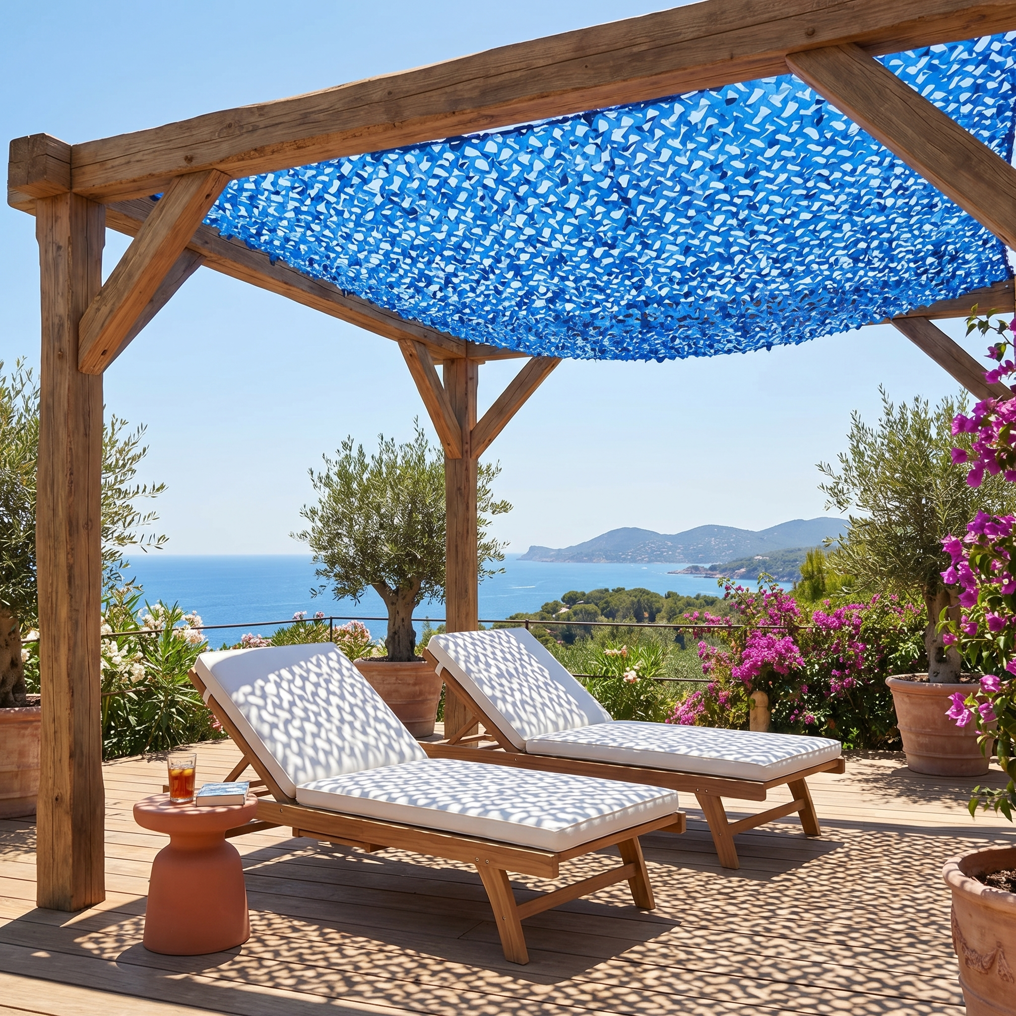 TheFrenchNets blue reinforced shade net spread above a poolside lounge area.