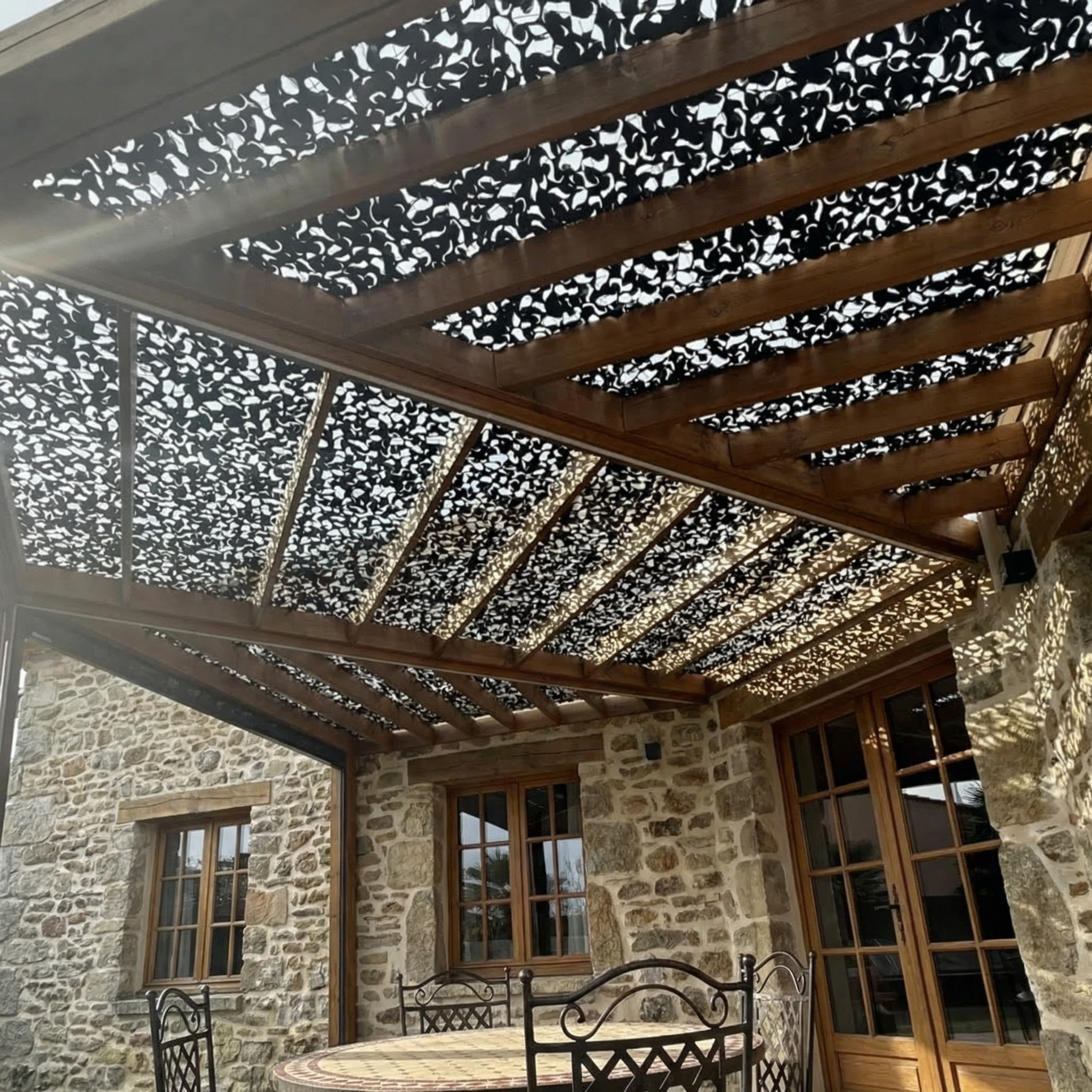 TheFrenchNets jet black shade net tensioned over a design-led terrace.