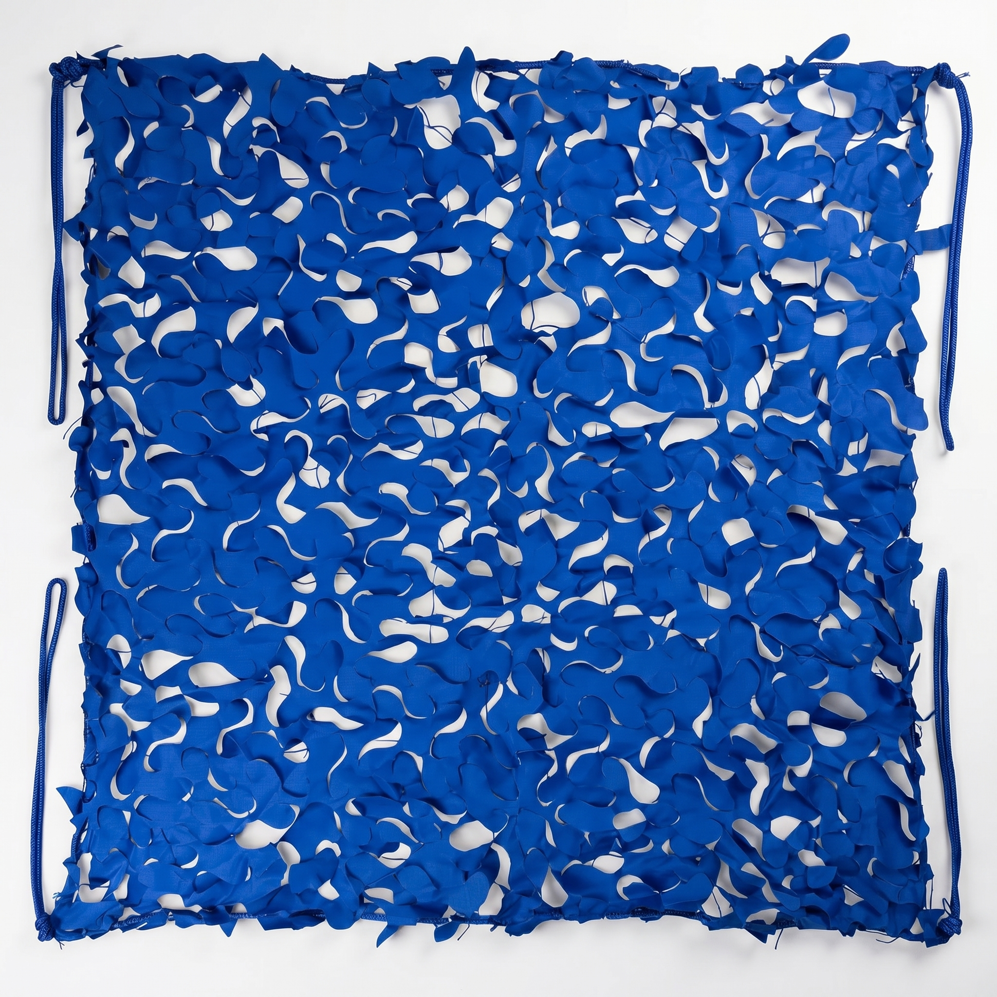 TheFrenchNets shade net fabric sample in sand laid on a wooden table.