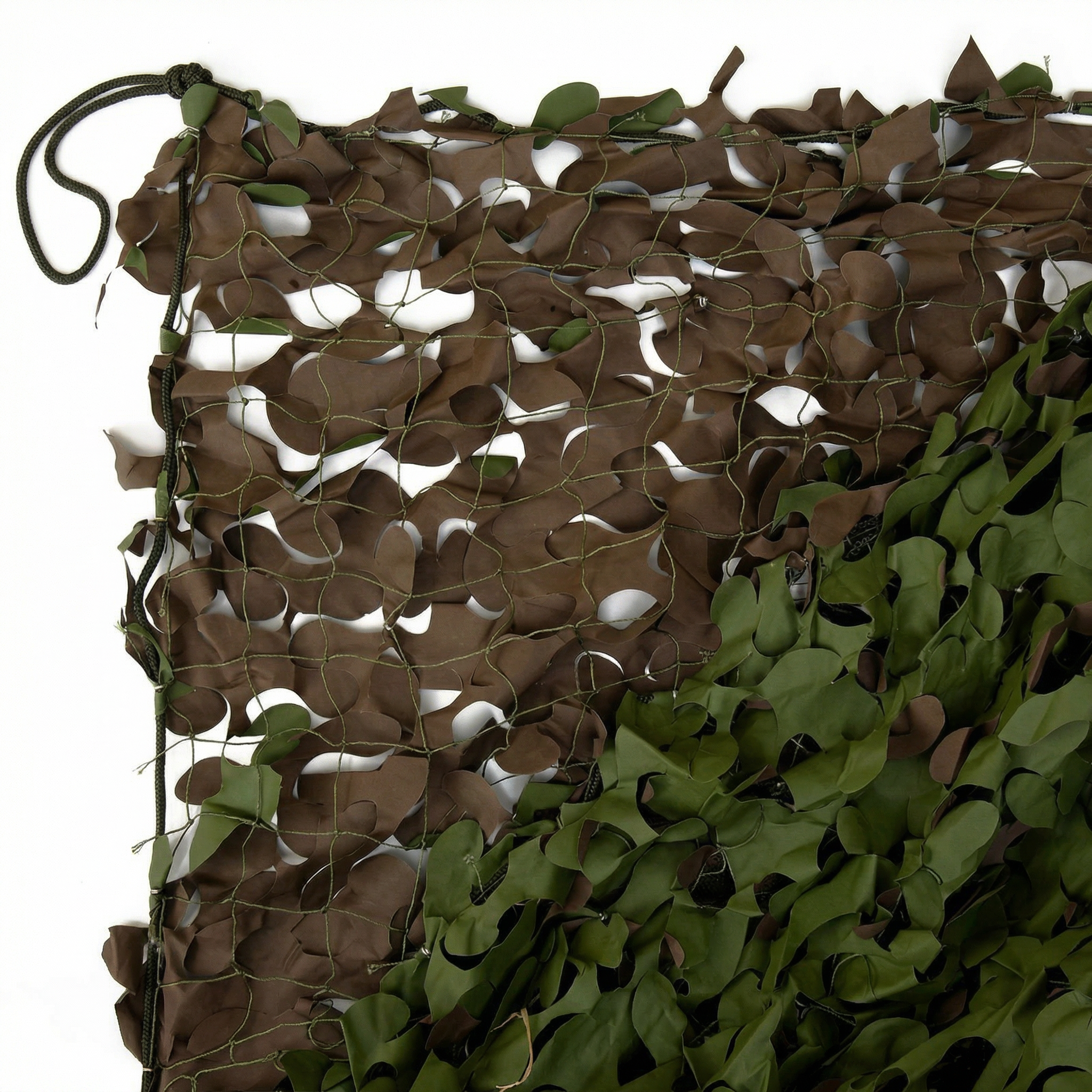 TheFrenchNets shade net fabric sample in white held against a stone wall.